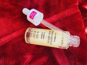 Wetnwild Prime Focus Brightening Primer Serum on red rug